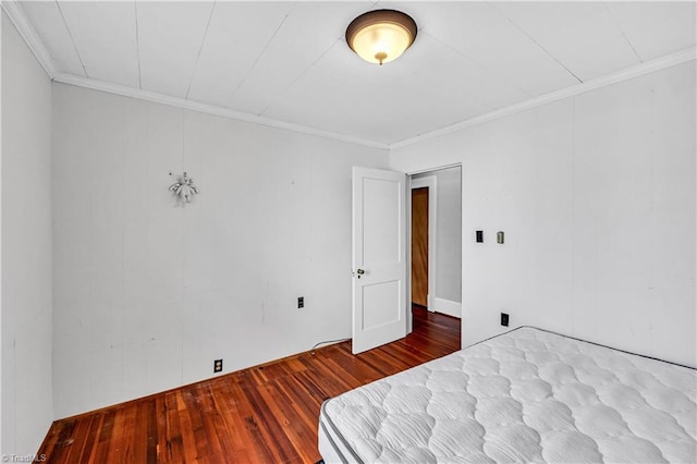 1112 Hamilton St, High Point, NC 27262 - unfurnished bedroom with wood-type flooring, crown molding, and a closet