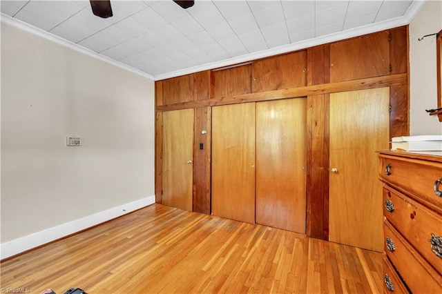 1112 Hamilton St, High Point, NC 27262 - unfurnished bedroom with crown molding, a closet, light wood-type flooring, and ceiling fan