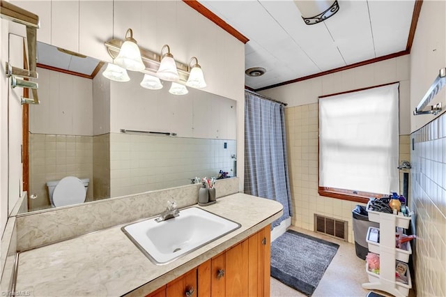 1112 Hamilton St, High Point, NC 27262 - full bathroom with tile walls, vanity, ornamental molding, and a shower with shower curtain