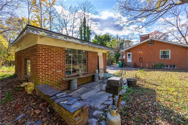 1112 Hamilton St, High Point, NC 27262 - view of side of property featuring a patio and brick siding