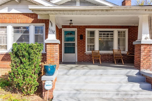 1112 Hamilton St, High Point, NC 27262 - entrance to property with a porch, brick siding, and a chimney