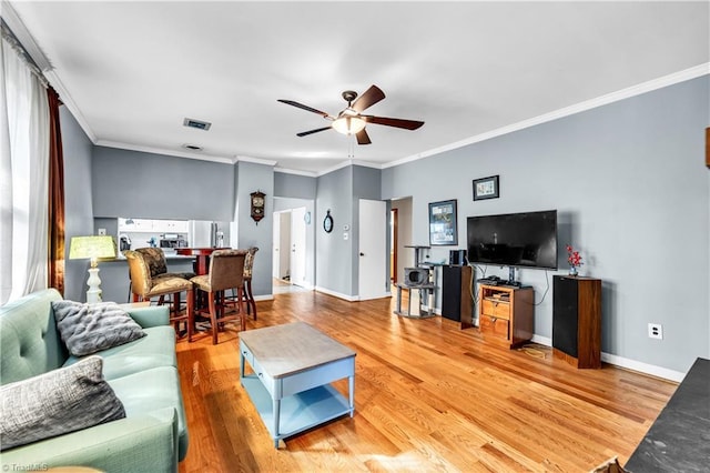 1112 Hamilton St, High Point, NC 27262 - living room featuring a ceiling fan, light wood-style flooring, and ornamental molding