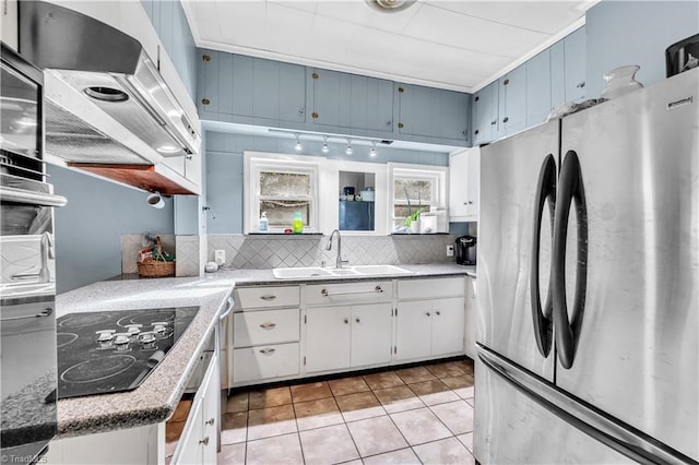 1112 Hamilton St, High Point, NC 27262 - kitchen with freestanding refrigerator, black electric cooktop, tasteful backsplash, and light tile patterned flooring