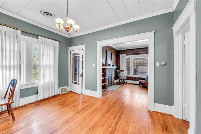 1112 Hamilton St, High Point, NC 27262 - foyer entrance featuring plenty of natural light, light wood finished floors, a chandelier, and ornamental molding