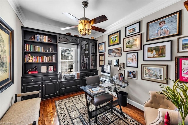 office area with baseboards, ornamental molding, ceiling fan, and dark wood-style flooring