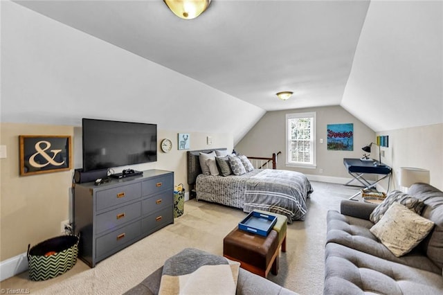 bedroom featuring baseboards, vaulted ceiling, and light colored carpet