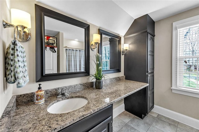 full bathroom featuring tile patterned floors, baseboards, and vanity