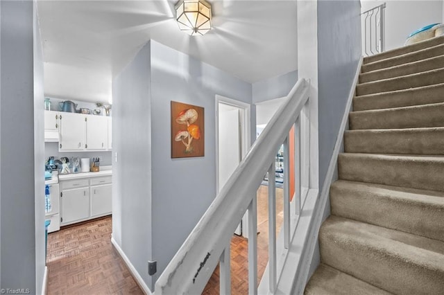 217 Village Ln Unit G, Greensboro, NC 27409 - stairway with baseboards