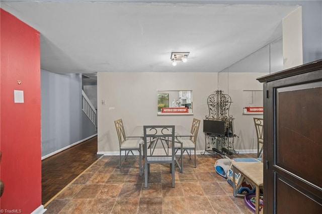 217 Village Ln Unit G, Greensboro, NC 27409 - dining room with stairway, stone finish flooring, and baseboards