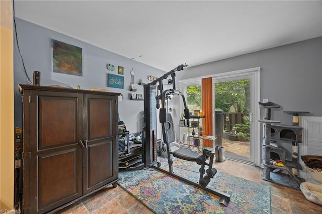 217 Village Ln Unit G, Greensboro, NC 27409 - workout area with light stone finish floors and a wood stove