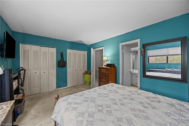 217 Village Ln Unit G, Greensboro, NC 27409 - bedroom with carpet, two closets, and an AC wall unit