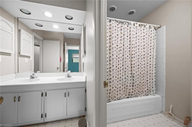 217 Village Ln Unit G, Greensboro, NC 27409 - full bath featuring shower / bath combo with shower curtain, double vanity, baseboards, and recessed lighting