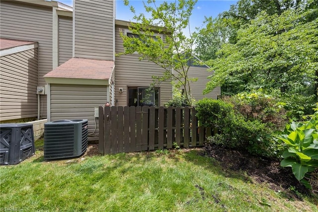 217 Village Ln Unit G, Greensboro, NC 27409 - rear view of property with central AC and a chimney