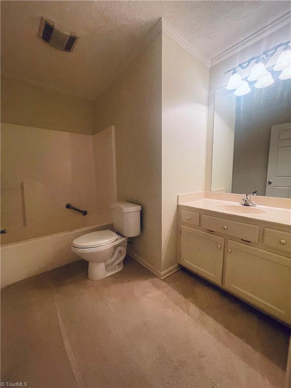 full bathroom featuring crown molding, a textured ceiling, toilet, shower / bath combination, and vanity