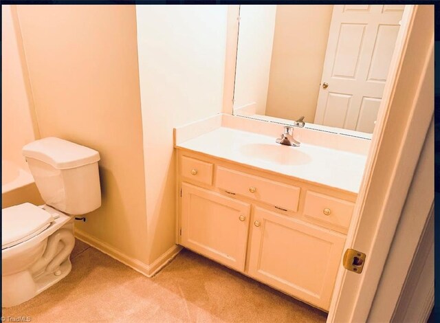 bathroom with toilet and vanity