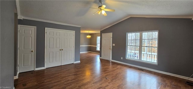 unfurnished bedroom with lofted ceiling, ceiling fan with notable chandelier, crown molding, a textured ceiling, and dark hardwood / wood-style flooring