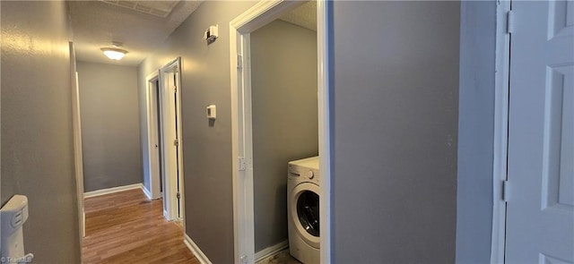 washroom featuring washer / dryer, wood-type flooring, and a textured ceiling