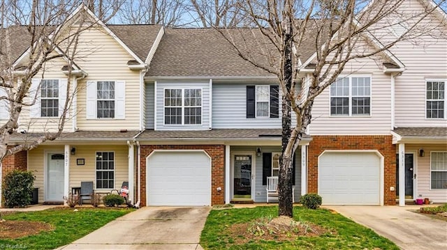 townhome / multi-family property featuring an attached garage, roof with shingles, concrete driveway, and brick siding