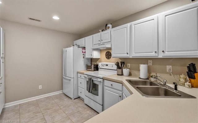 kitchen with white cabinetry, a sink, white appliances, under cabinet range hood, and baseboards