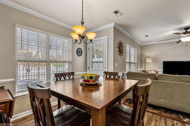 dining space with dark wood-style flooring, visible vents, and a healthy amount of sunlight