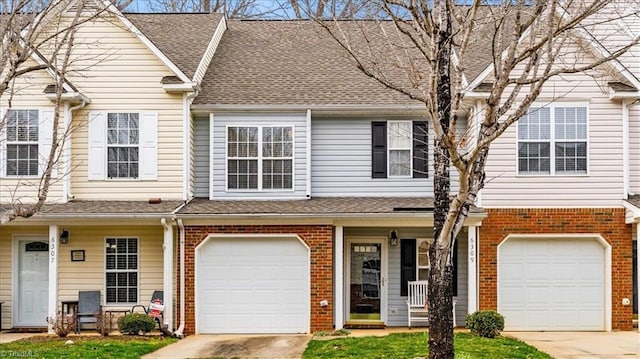 view of property with concrete driveway, brick siding, an attached garage, and a shingled roof