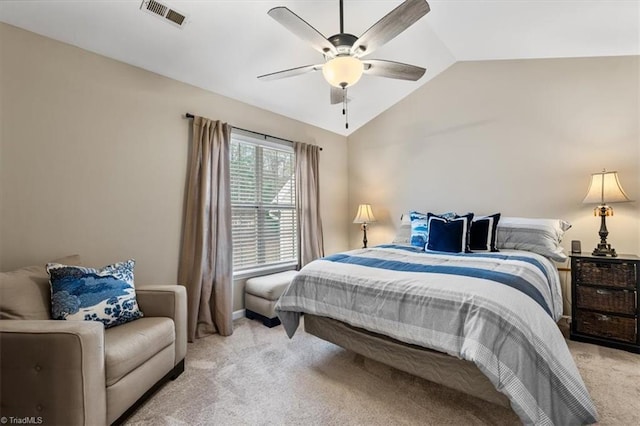 bedroom with ceiling fan, visible vents, vaulted ceiling, and light colored carpet