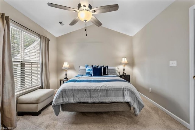 bedroom featuring lofted ceiling, ceiling fan, visible vents, baseboards, and carpet