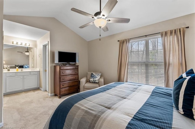 bedroom featuring baseboards, connected bathroom, a ceiling fan, light colored carpet, and vaulted ceiling