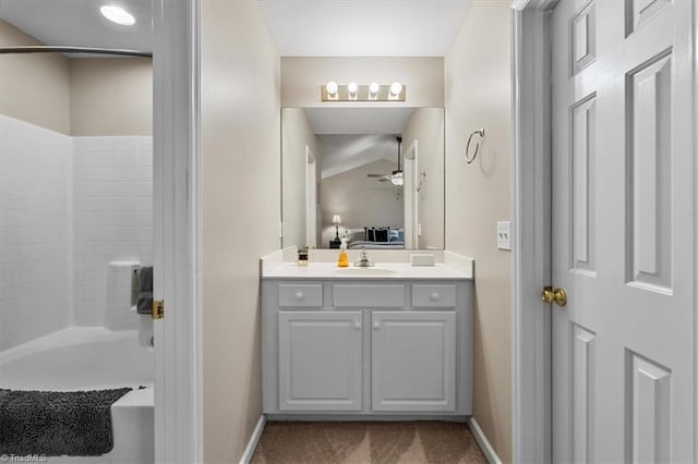 bathroom featuring vanity, baseboards, a ceiling fan, and ensuite bathroom