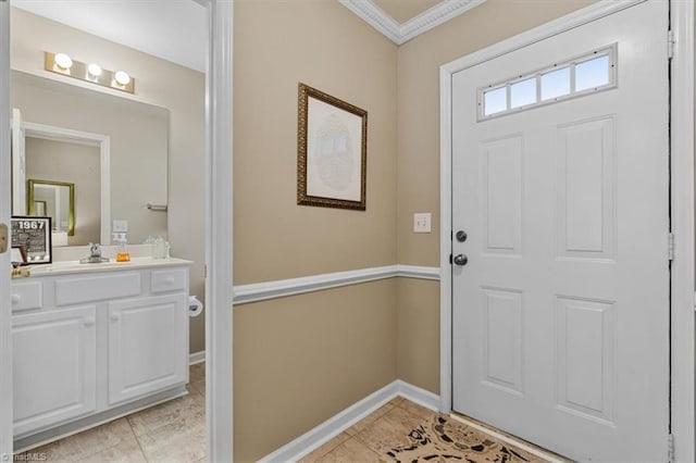 foyer with light tile patterned floors, baseboards, and crown molding