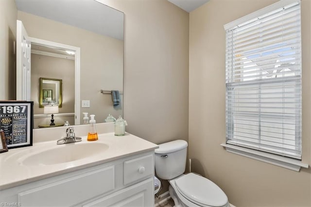 bathroom featuring toilet and vanity