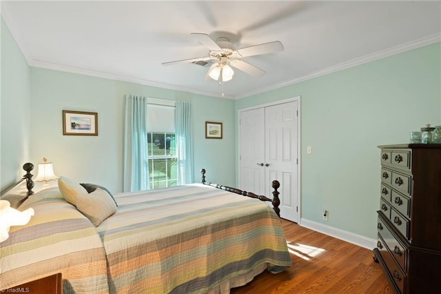 bedroom featuring wood-type flooring, a closet, ceiling fan, and ornamental molding