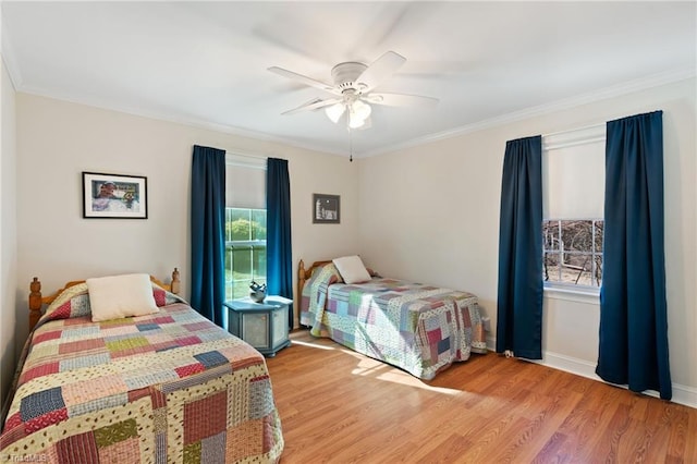 bedroom with ceiling fan, light wood-type flooring, and ornamental molding