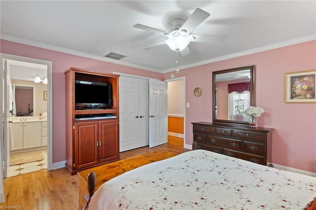 bedroom featuring connected bathroom, light hardwood / wood-style flooring, ceiling fan, and crown molding