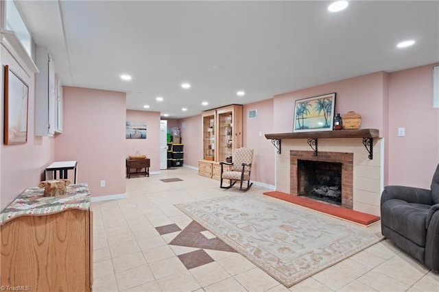 tiled living room featuring a brick fireplace