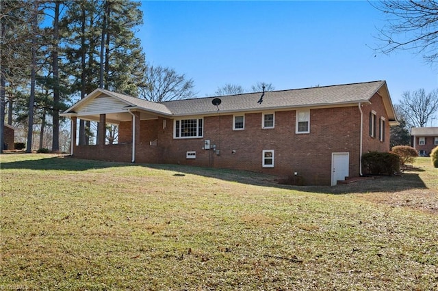 rear view of house featuring a yard