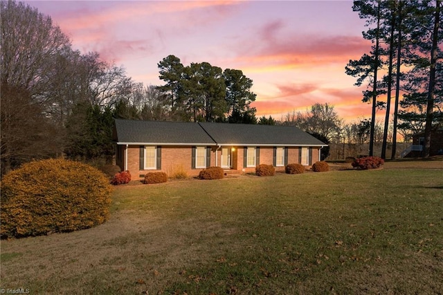 ranch-style house with a yard