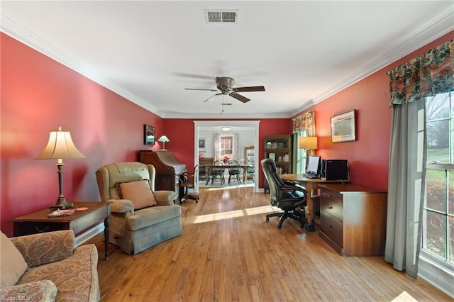 office space featuring light hardwood / wood-style floors, ceiling fan, and ornamental molding