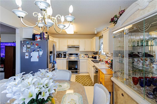 kitchen with sink, an inviting chandelier, and appliances with stainless steel finishes