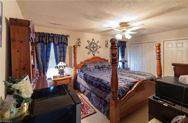 bedroom with a textured ceiling and ceiling fan