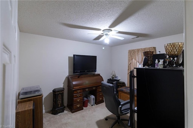 carpeted office space with ceiling fan and a textured ceiling