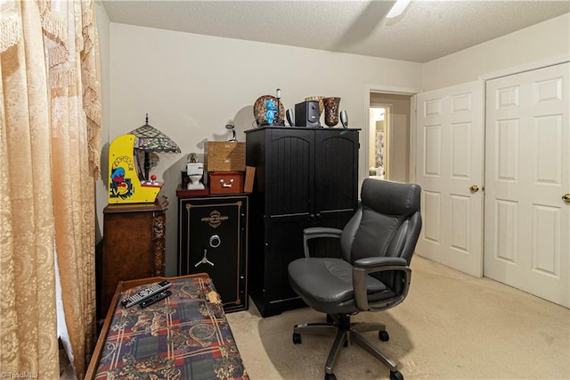 home office with a textured ceiling and light carpet