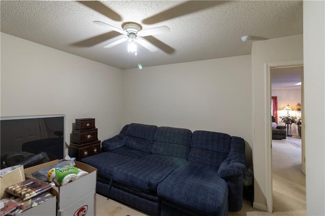 carpeted living room with a textured ceiling and ceiling fan