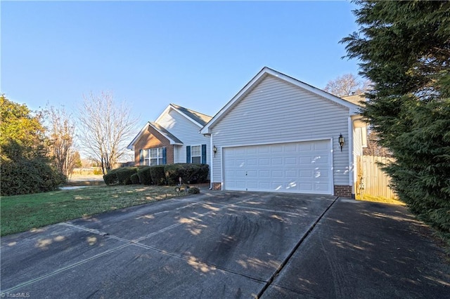 ranch-style home featuring a garage and a front lawn