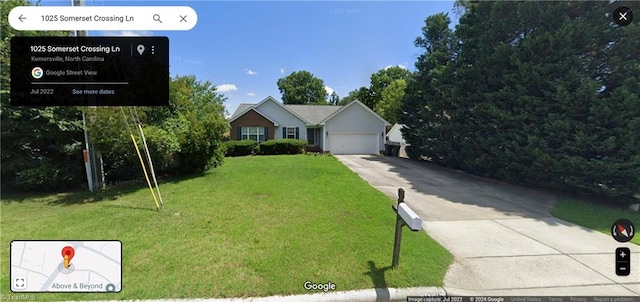 view of front of property with a front yard and a garage