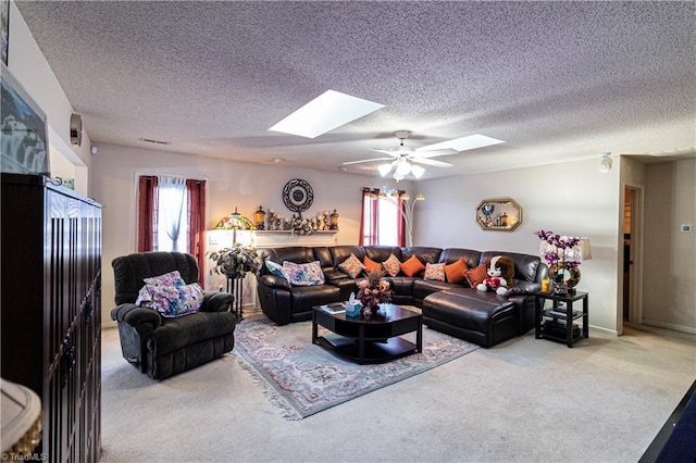 living room featuring a wealth of natural light, carpet, and a skylight