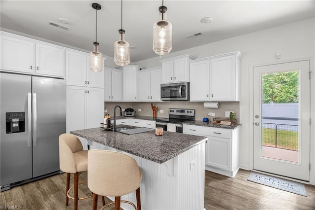 4062 Monteray Cir, High Point, NC 27265 - kitchen featuring appliances with stainless steel finishes, a sink, dark wood-style flooring, and white cabinetry