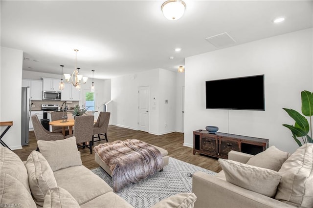 4062 Monteray Cir, High Point, NC 27265 - living room with dark wood-style flooring, recessed lighting, baseboards, and a chandelier
