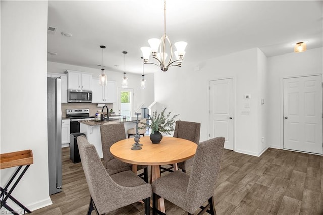 4062 Monteray Cir, High Point, NC 27265 - dining room with dark wood-type flooring, baseboards, and a chandelier