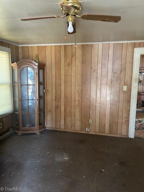 spare room with wooden walls and ceiling fan